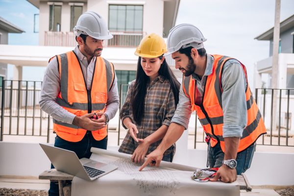 civil-engineer-construction-worker-architects-wearing-hardhats-safety-vests-are-working-together-construction-site-building-home-cooperation-teamwork-concept Residential Construction